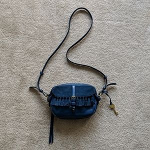 Small blue purse with suede talks and brass trim